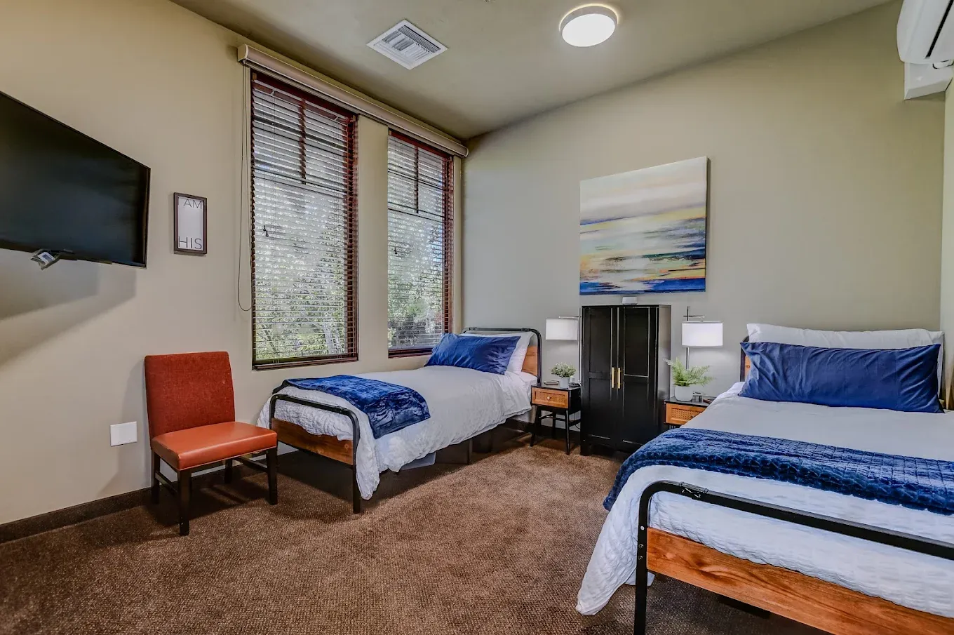 A shared bedroom at AnchorPoint with two made beds