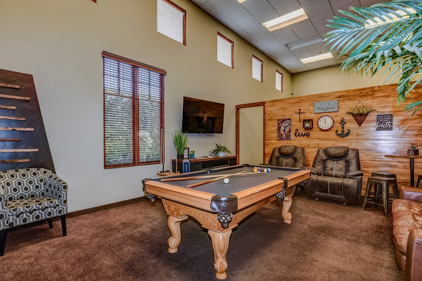 The lounge at AnchorPoint, with a pool table and recliners
