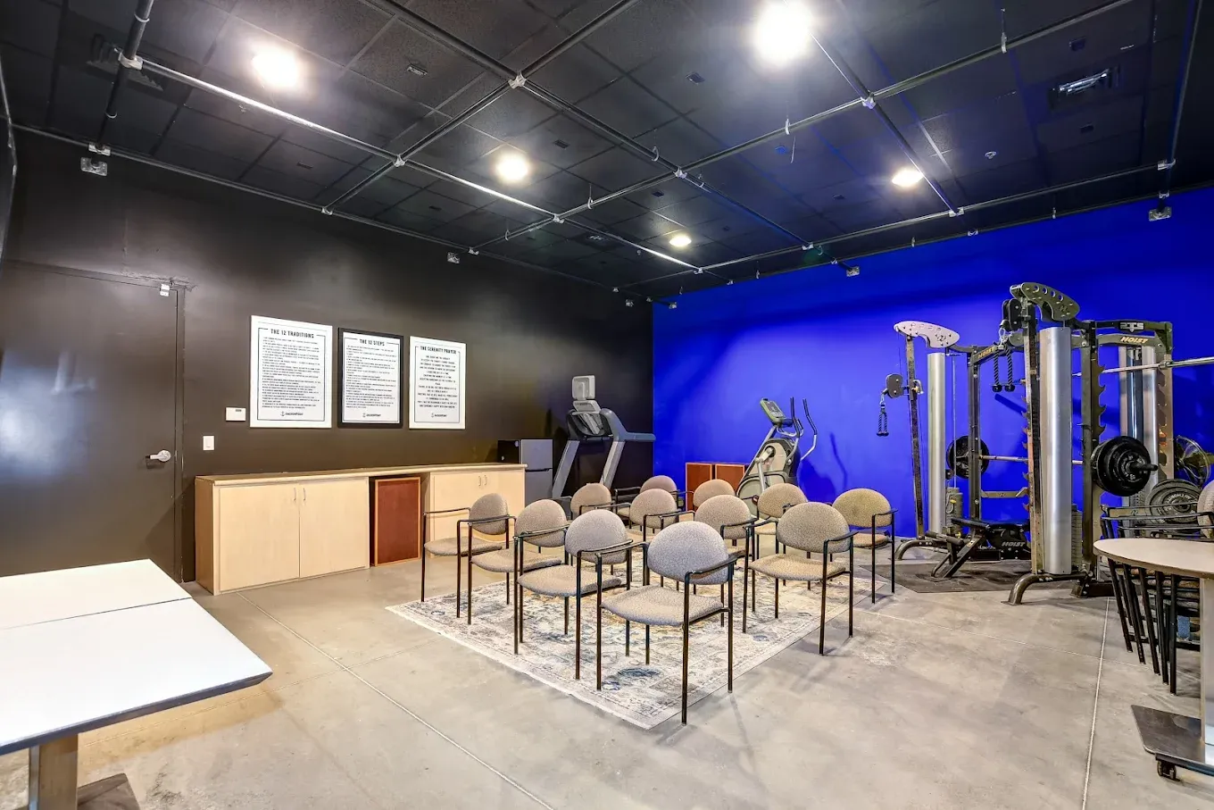 The gym at AnchorPoint with a weight rack and cable machine