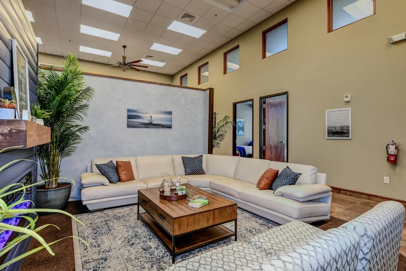 The living room at AnchorPoint: sofas, a coffee table and tall windows